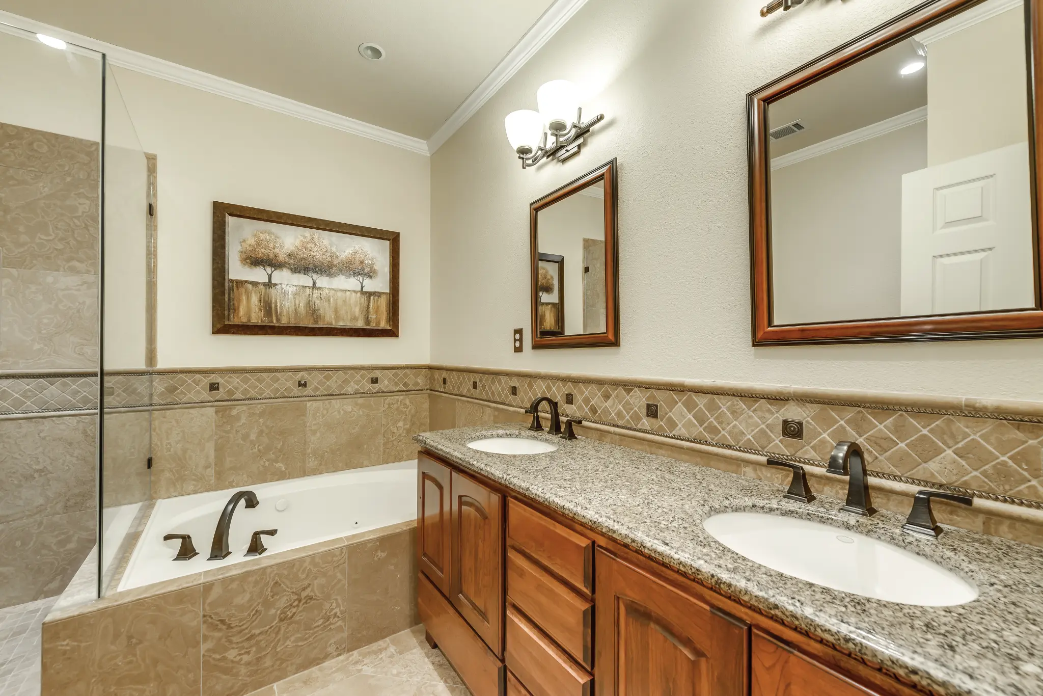 After: Master bathroom with granite double vanity and soaking tub – 10802 Tree Shadow Ln, Frisco TX