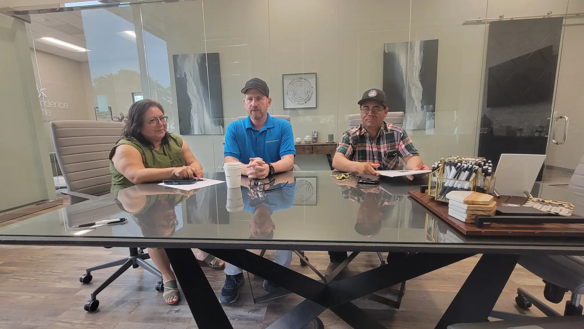 Shannan Coblentz, seller Benjamin and his wife at closing table — Providence Title, Fort Worth TX