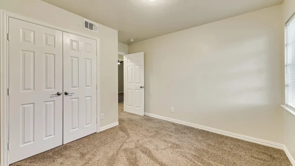 Master bedroom with new paint, doors, carpet, baseboard and trim
