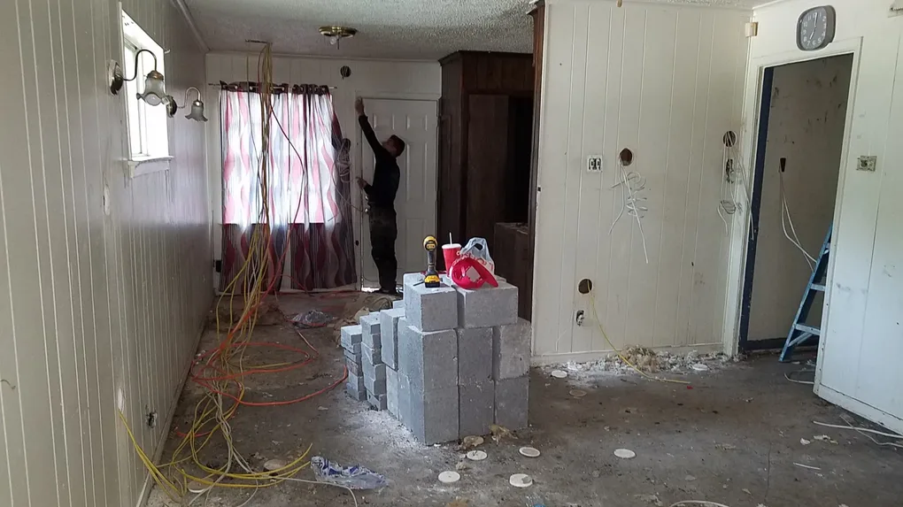 Jumping into the project with all new electrical wire and leveling the slab with concrete piers, the garage needed it too