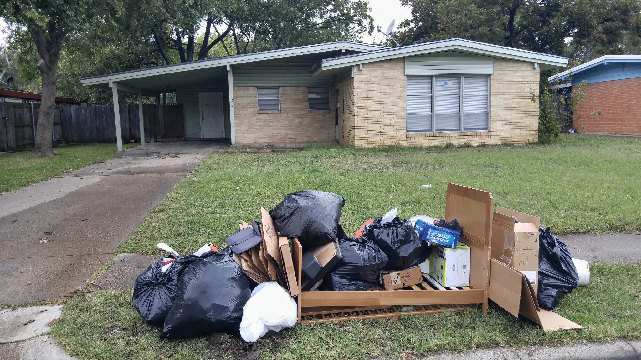 1823 Winthrop St Irving TX exterior before renovation with tenant debris on lawn - DFW I Buy Houses