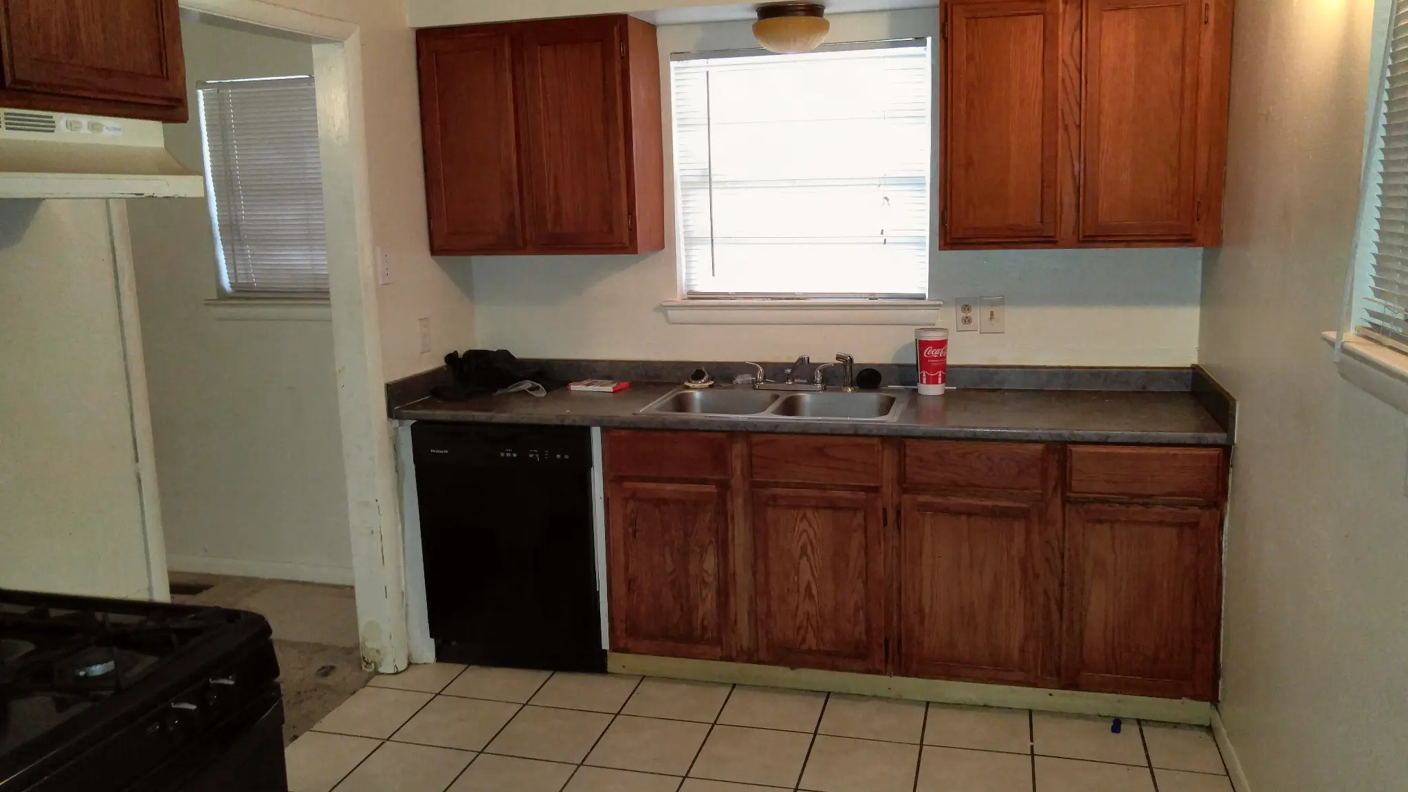 1823 Winthrop St Irving TX kitchen before renovation with dated oak cabinets - DFW I Buy Houses